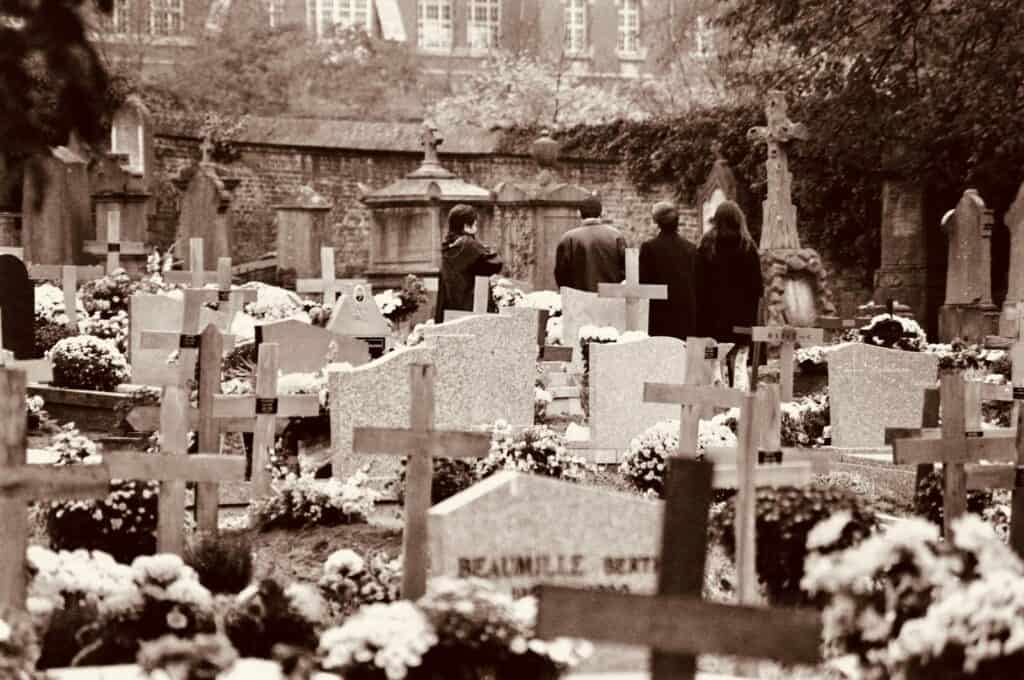 Group of People Standing at the Cemetery