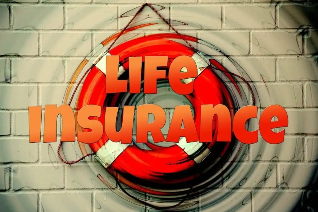 An orange life preserver with the words "Life Insurance" is mounted on a brick wall, symbolizing safety as emphasized in life insurance policy review questions.