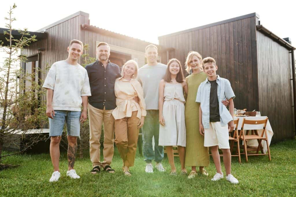 A joyful family posing together in a sunny outdoor setting, enjoying quality time.